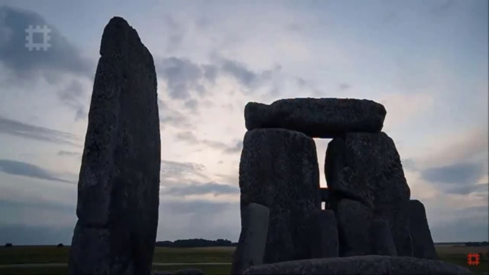 The standing stones of Stonehenge under a grey sky, from the 2020 summer solstice live stream.